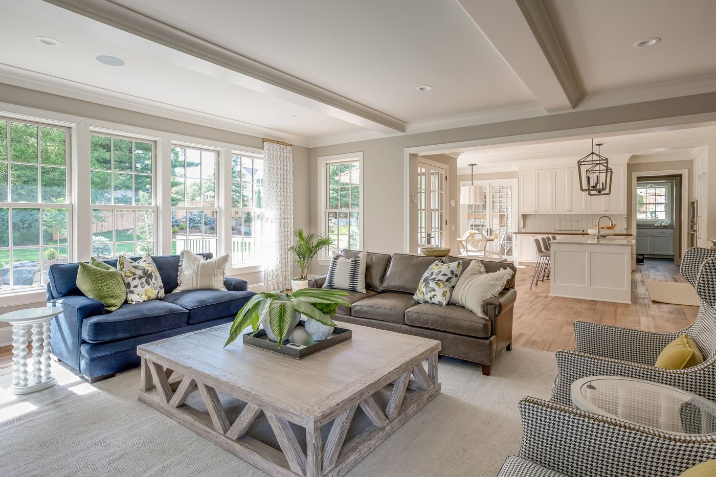 Bright living room with a wall of white-framed windows